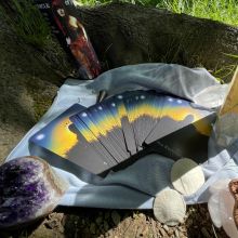 Cards under tree with candle, shells and amythest